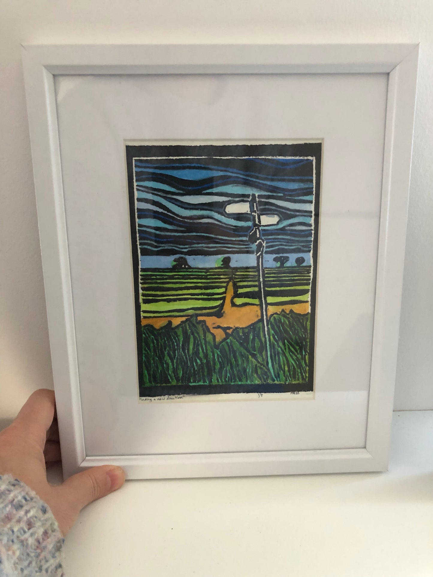 "Finding A New Direction" hand painted linocut in a white wooden frame